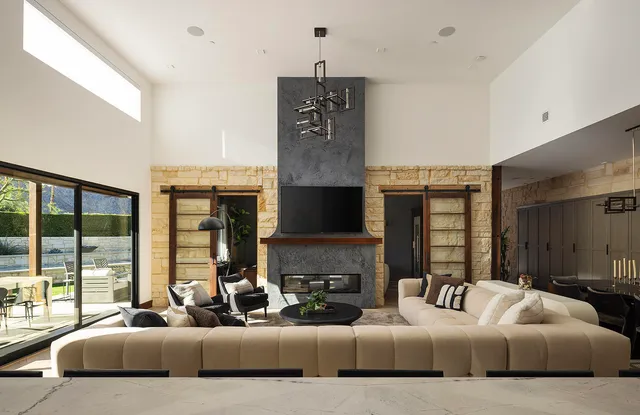 a living room with furniture or couch and a chandelier