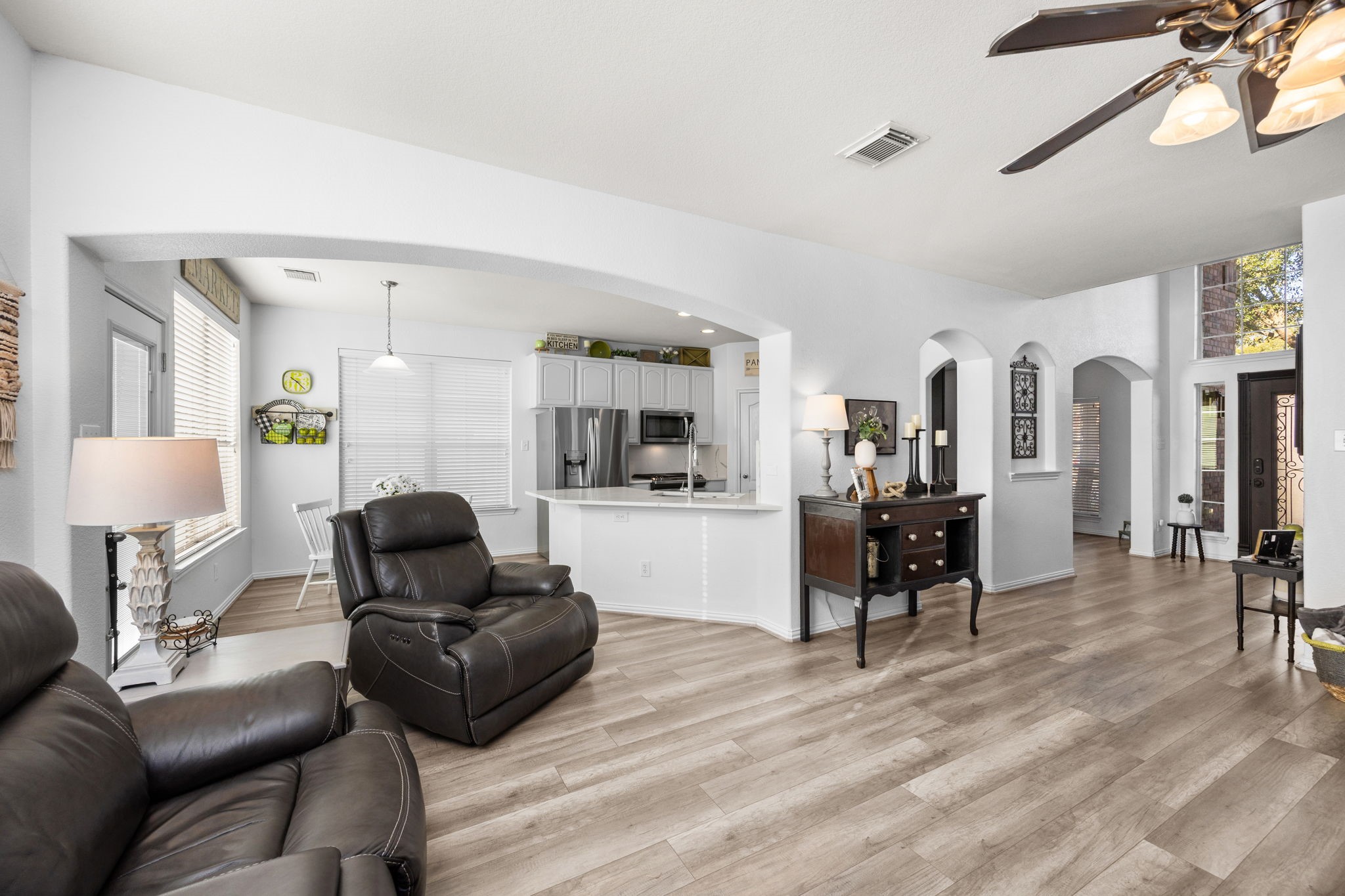 6911 Hamilton Falls Lane Spring, TX 77379 - Photo 12 of 42 a living room with furniture and a dining table with kitchen view