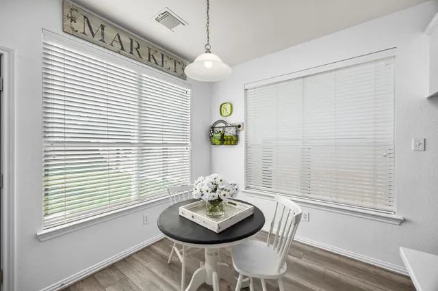 a living room with furniture chandelier and a view of kitchen