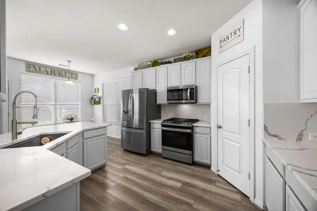 a living room with furniture ceiling fan and a window