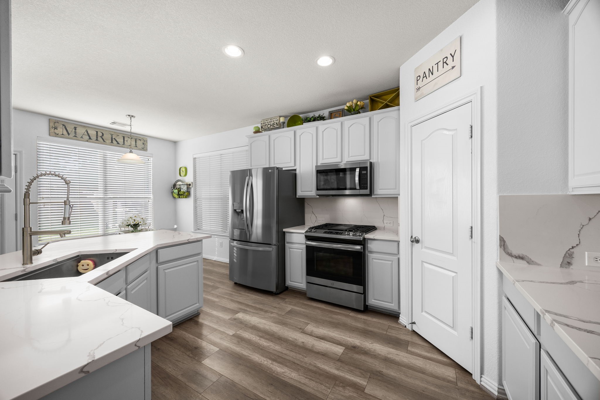 6911 Hamilton Falls Lane Spring, TX 77379 - Photo 17 of 42 a kitchen with stainless steel appliances granite countertop a sink stove and refrigerator