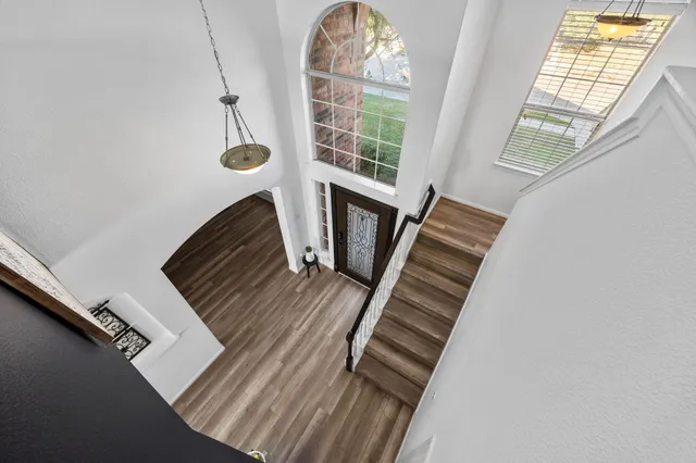 a bedroom with furniture and a wooden floor