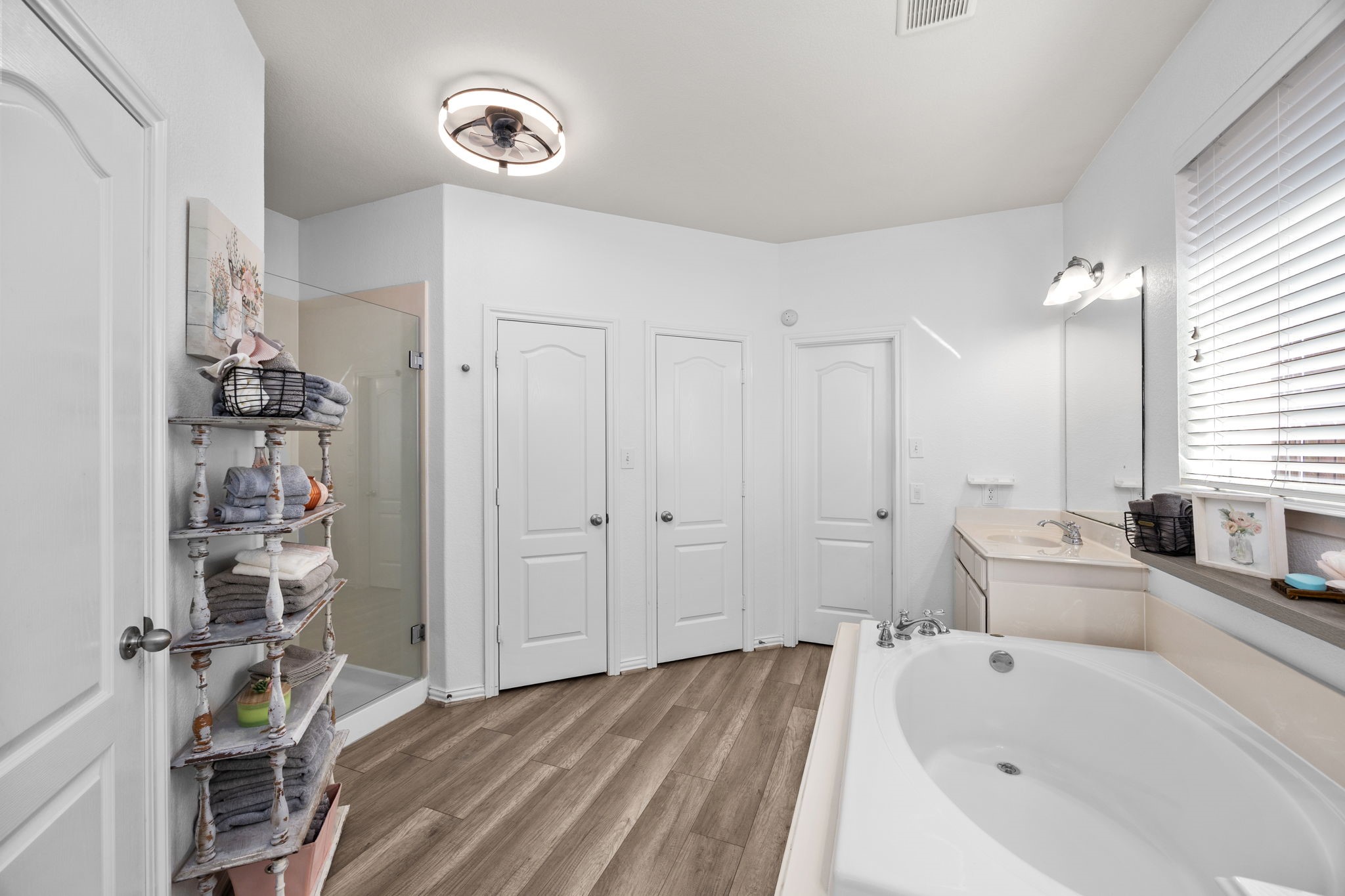 6911 Hamilton Falls Lane Spring, TX 77379 - Photo 23 of 42 a bathroom with a tub sink and mirror