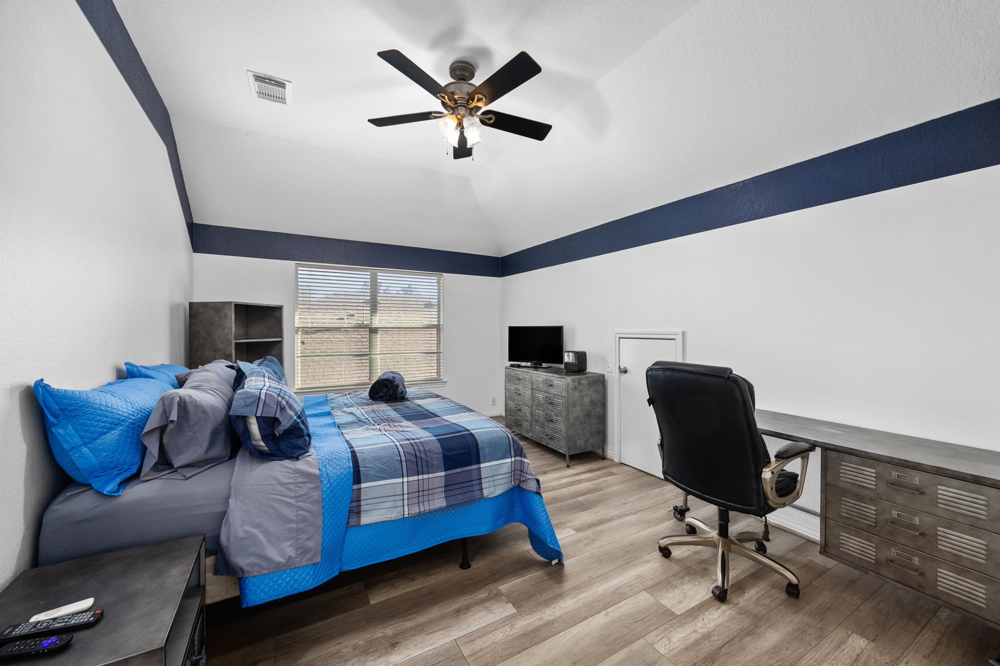 6911 Hamilton Falls Lane Spring, TX 77379 - Photo 37 of 42 a bedroom with a bed a chair and a large window