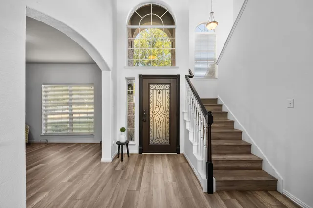 a view of an entryway with wooden floor