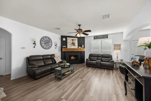 a living room with furniture fireplace and window