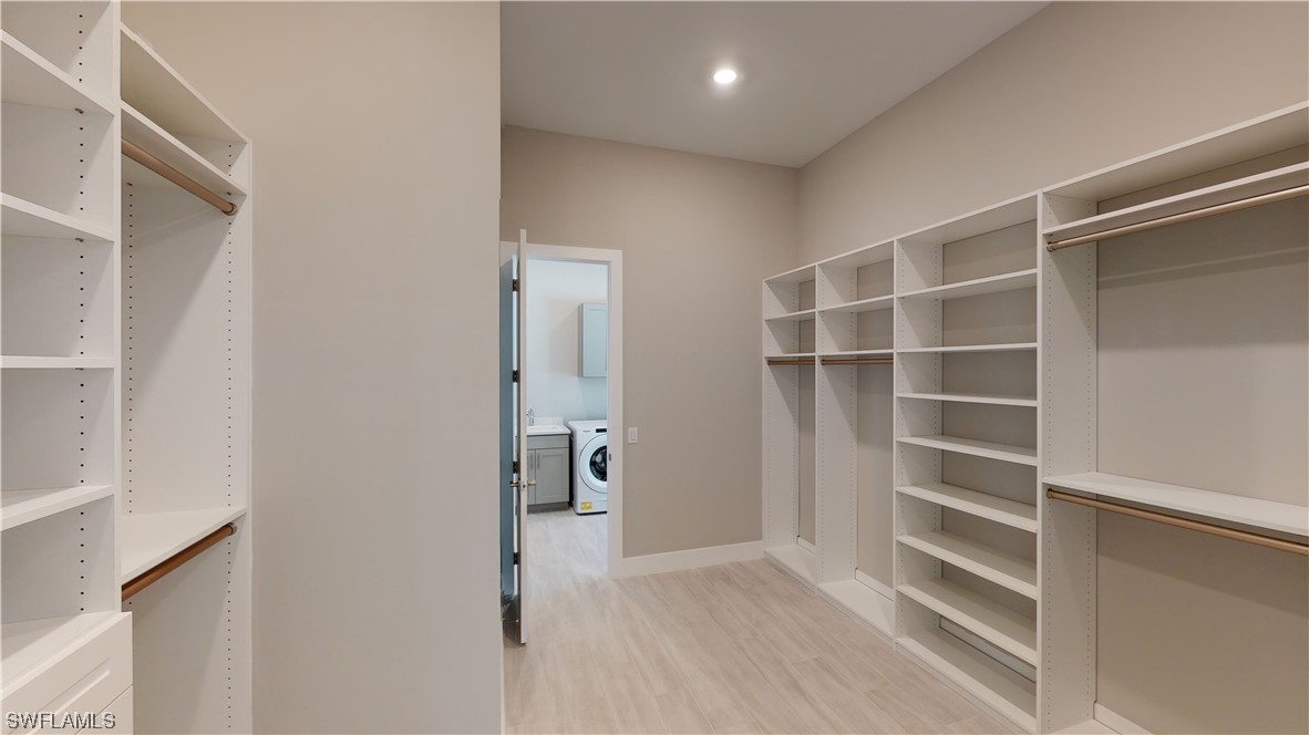 16257 Verilyn Circle Naples, FL 34110 - Photo 23 of 40 a view of closet area with empty racks