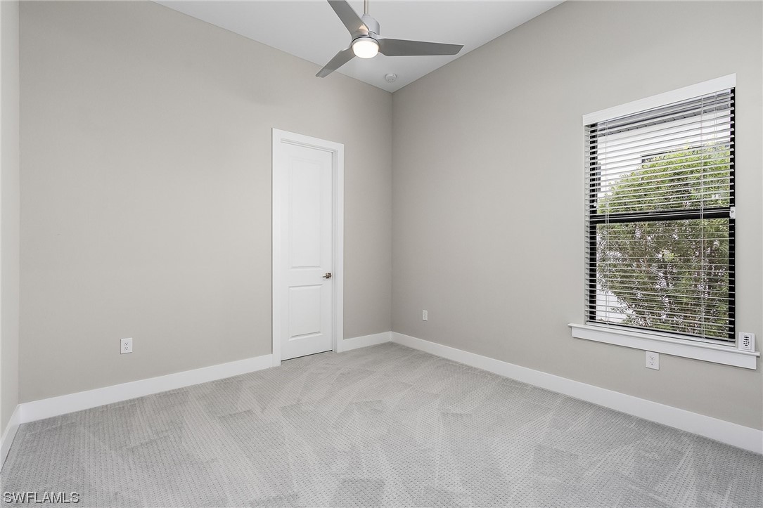 16257 Verilyn Circle Naples, FL 34110 - Photo 29 of 40 an empty room with a window and ceiling fan