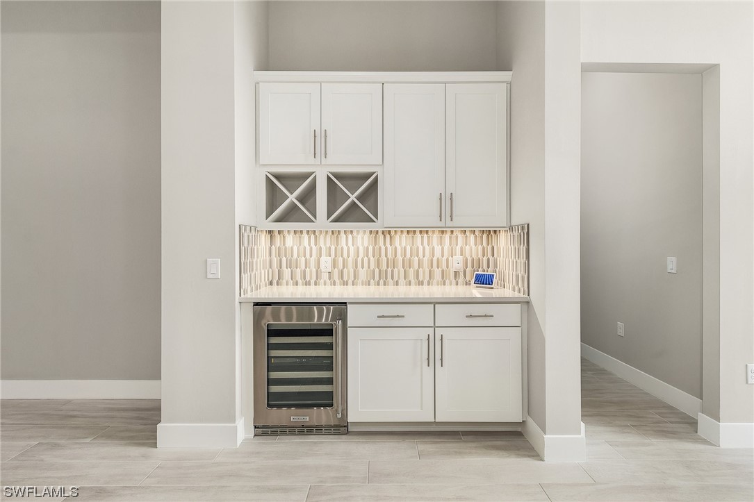 16257 Verilyn Circle Naples, FL 34110 - Photo 10 of 40 a kitchen with white cabinets and a sink