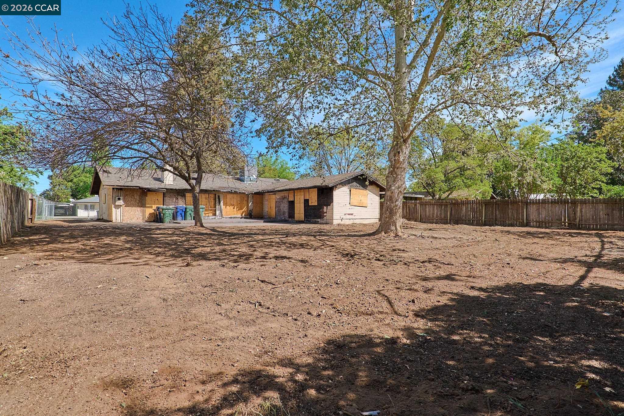 3530 William Way Sacramento, CA 95821 - Photo 5 of 27 a backyard of a house with large trees and outdoor seating