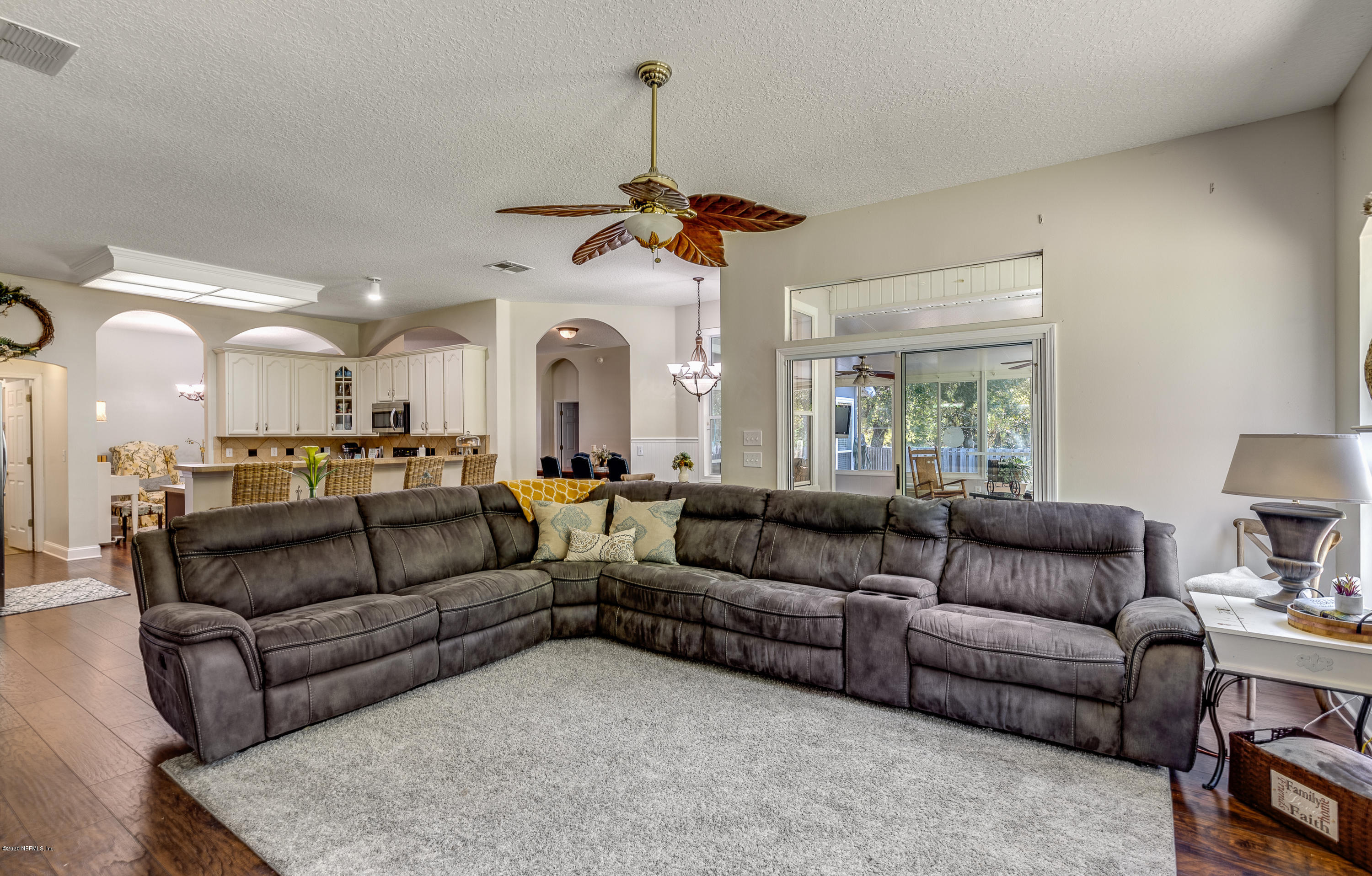 1798 Covington Lane Fleming Island, FL 32003 - Photo 13 of 30 a living room with furniture a ceiling fan a rug and a window