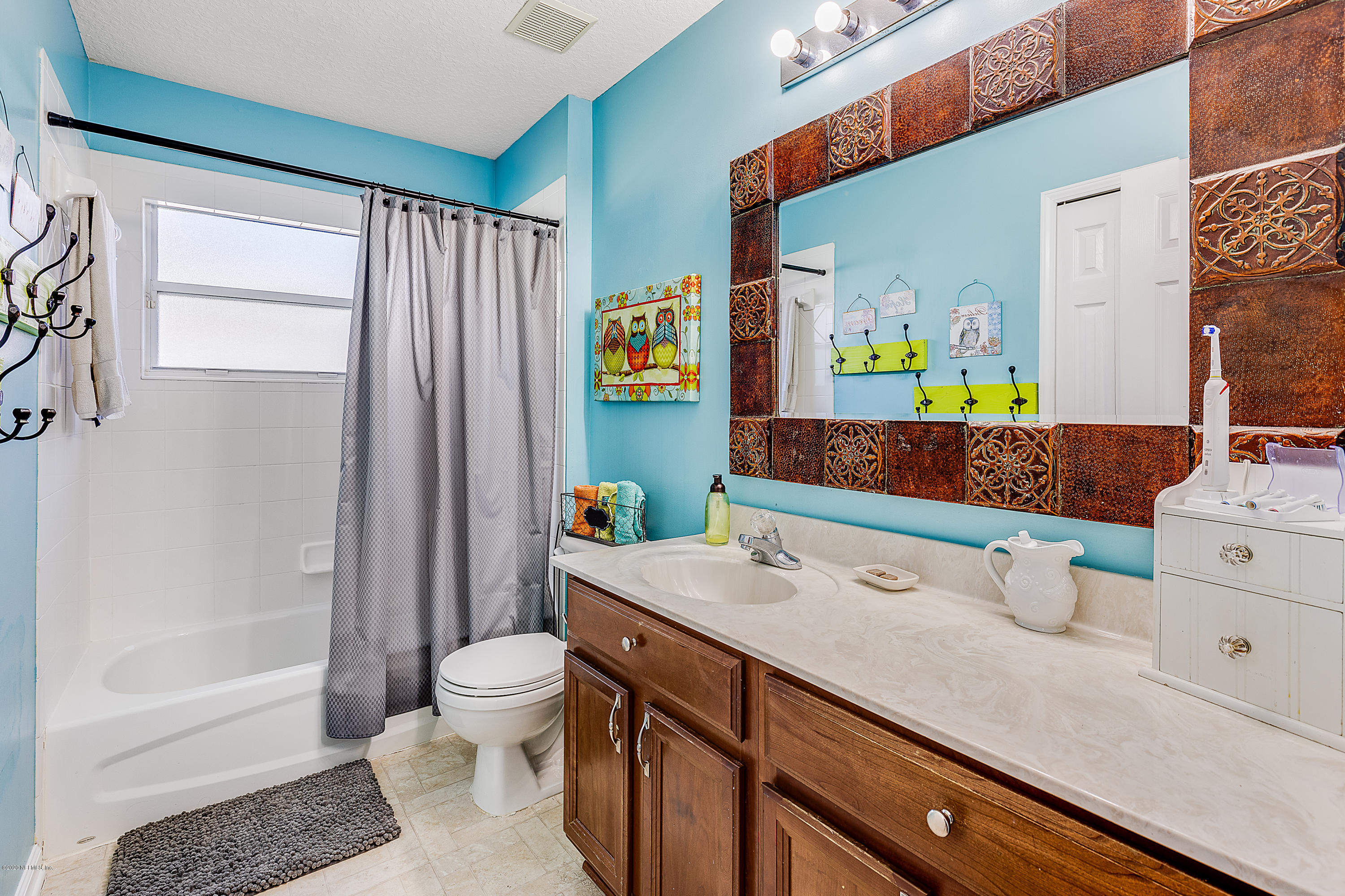 1798 Covington Lane Fleming Island, FL 32003 - Photo 20 of 30 a bathroom with a sink a toilet and shower