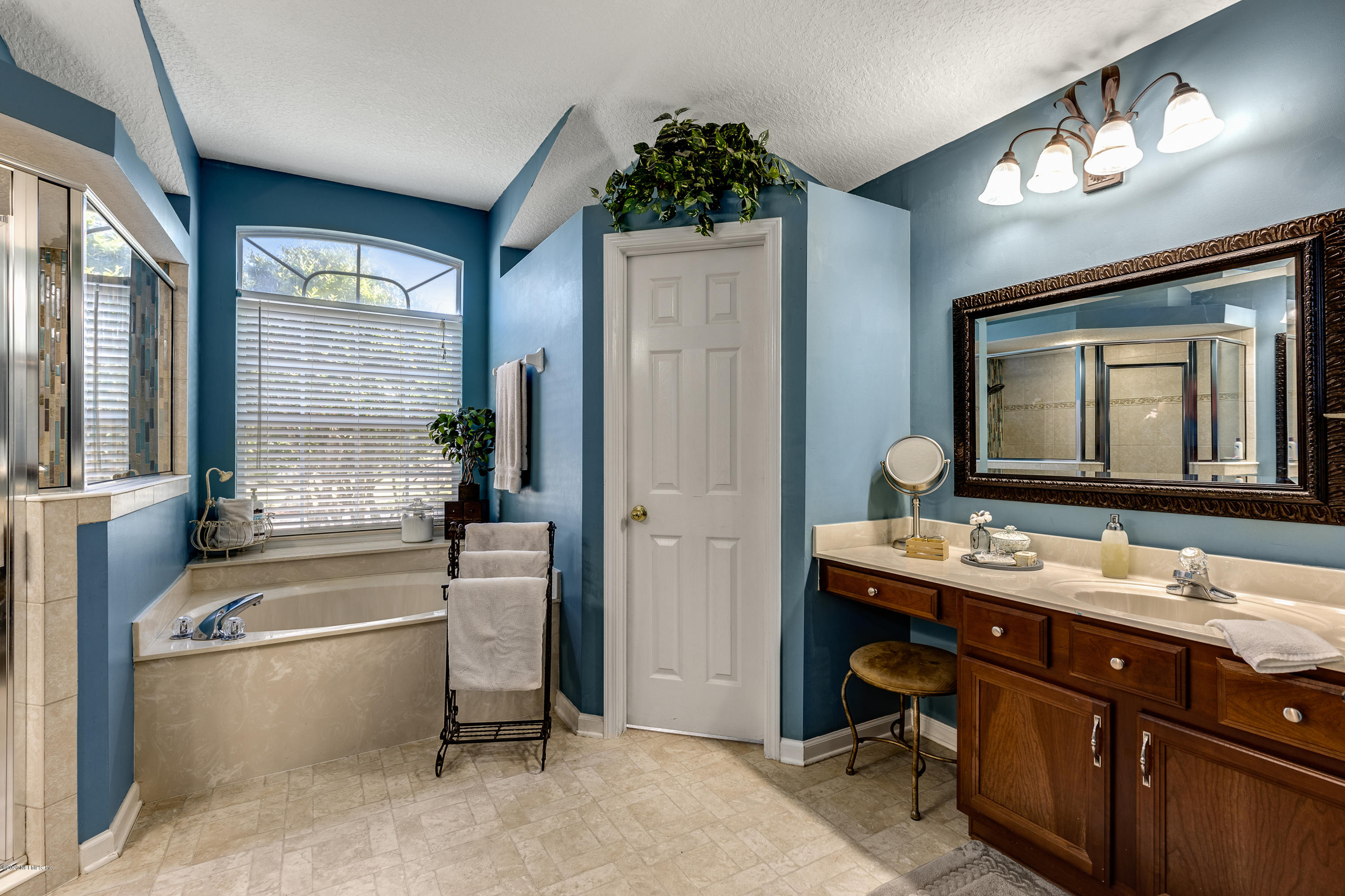 1798 Covington Lane Fleming Island, FL 32003 - Photo 25 of 30 a bathroom with a tub double sink window and mirror