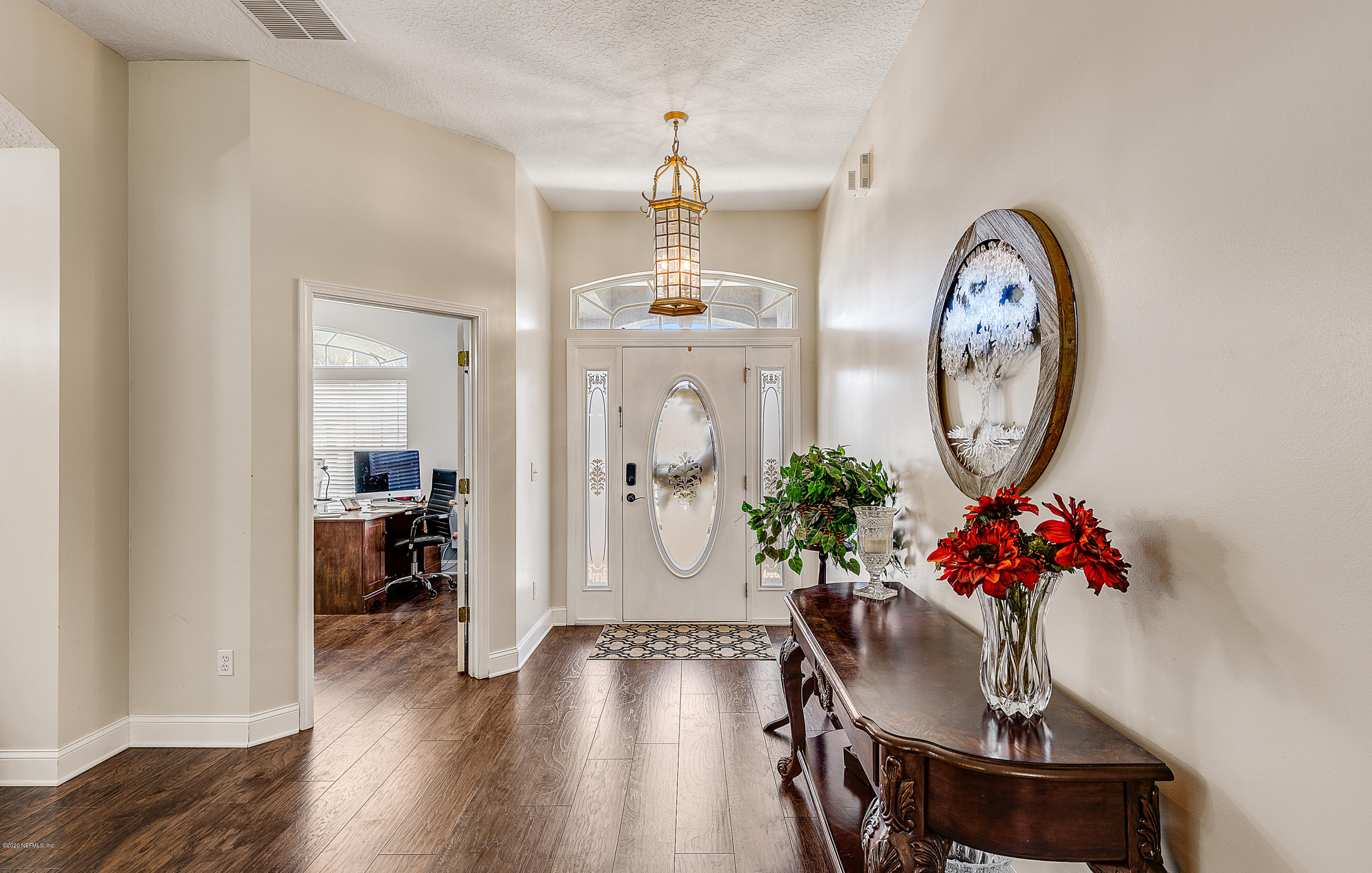 1798 Covington Lane Fleming Island, FL 32003 - Photo 4 of 30 a view of a dining room with furniture wooden floor and a chandelier