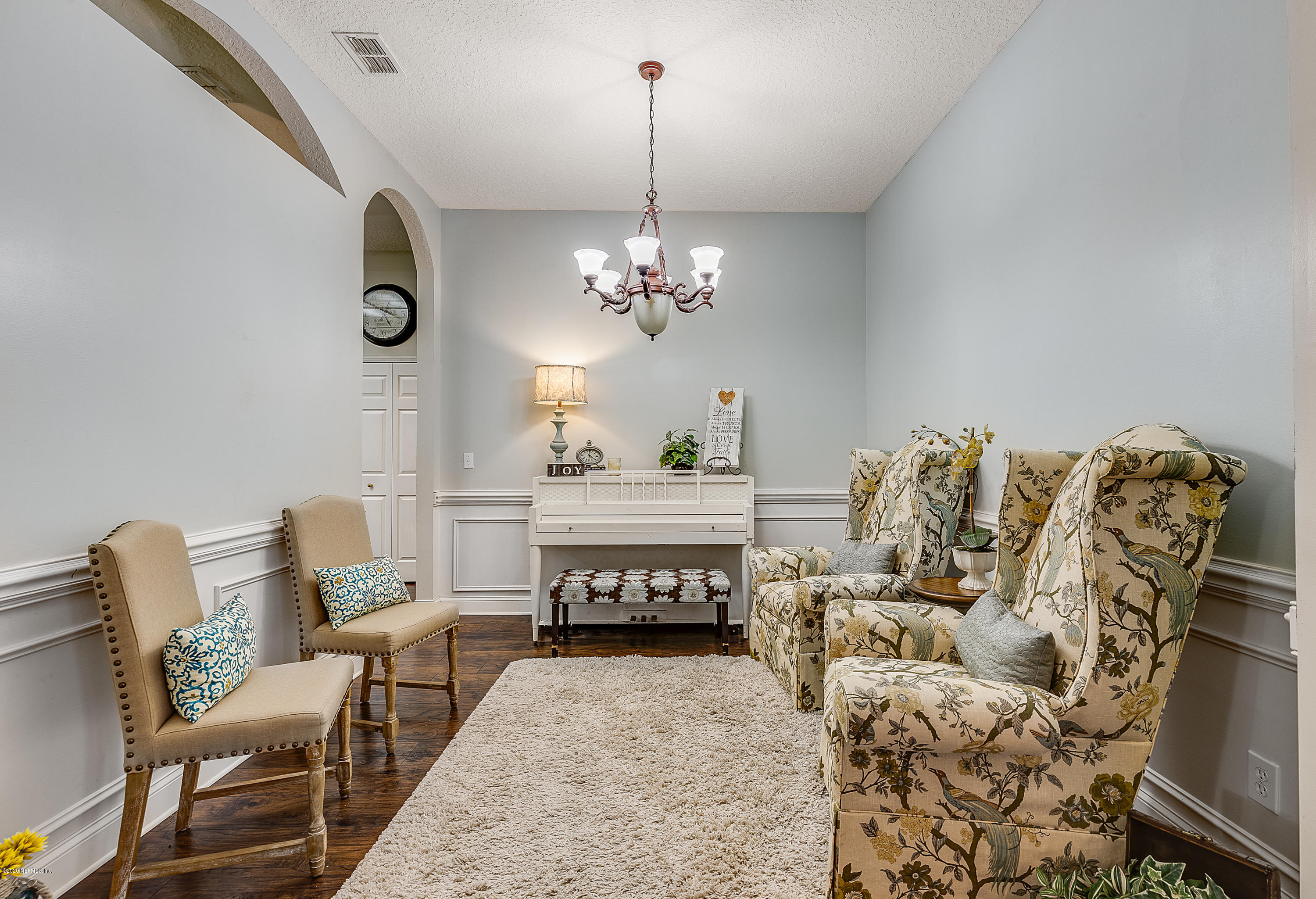 1798 Covington Lane Fleming Island, FL 32003 - Photo 6 of 30 a bedroom with furniture and a chandelier