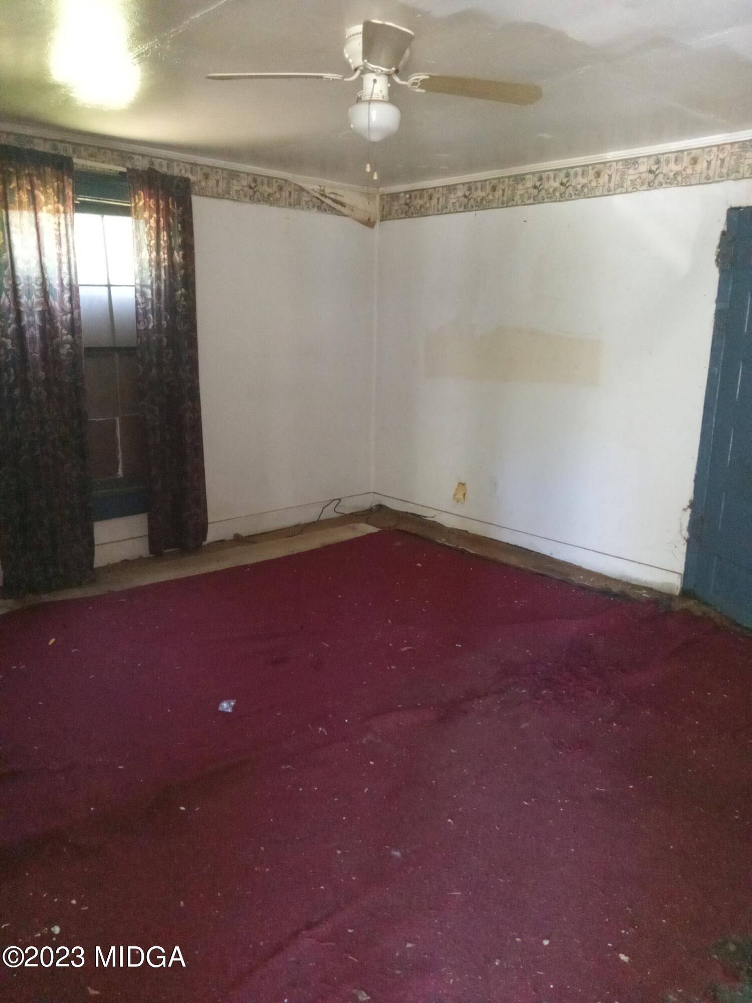 1123 Smith Street Macon, GA 31217 - Photo 6 of 17 en empty room with windows and ceiling fan