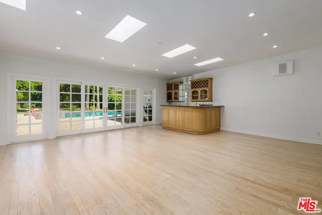 a kitchen with a stove a sink a counter space and a window
