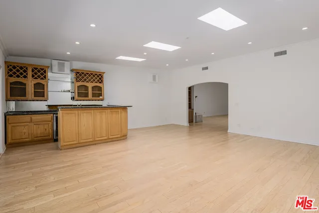 a kitchen with a stove a sink and a cabinets