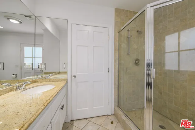 an empty room with wooden floor chandelier and windows