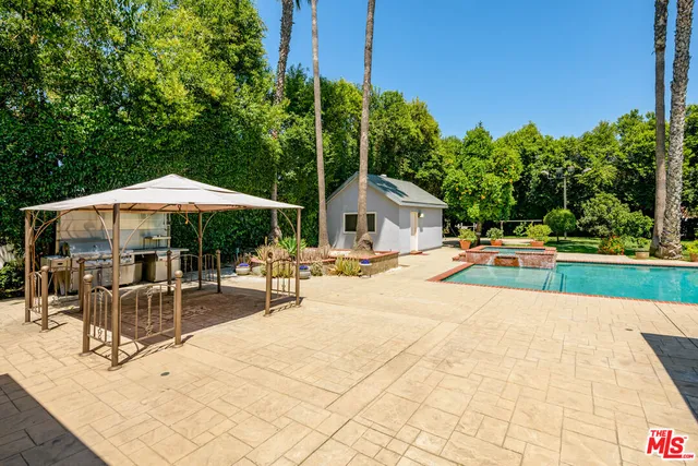 a front view of house with yard and swimming pool