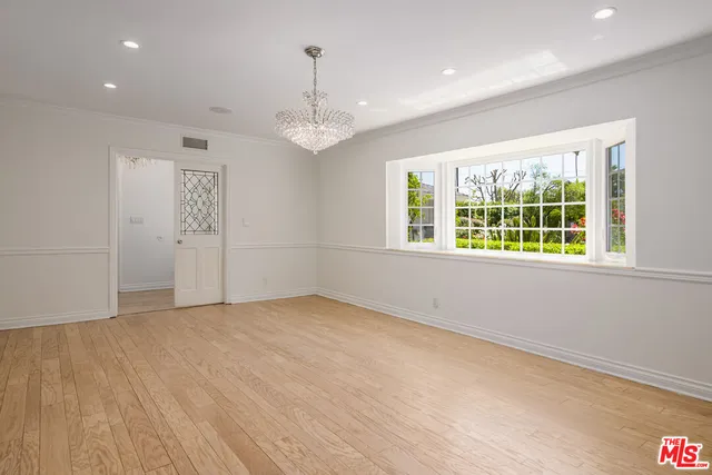 a view of an empty room with a fireplace and a window