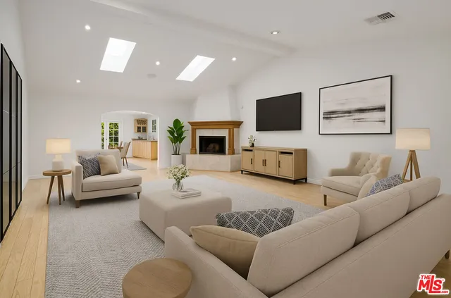 a view of an empty room with a fireplace and a window