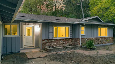a view of a brick house with a large windows