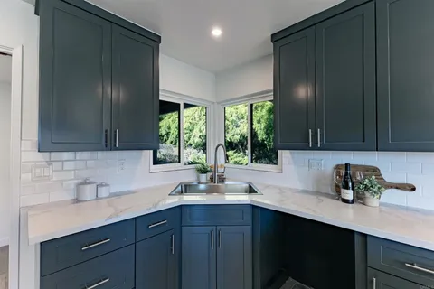 a kitchen with a sink cabinets and window