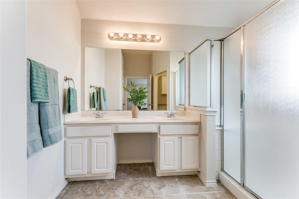 5213 Westheimer Road Fort Worth, TX 76244 - Photo 14 of 25 a bathroom with a double vanity sink and mirror
