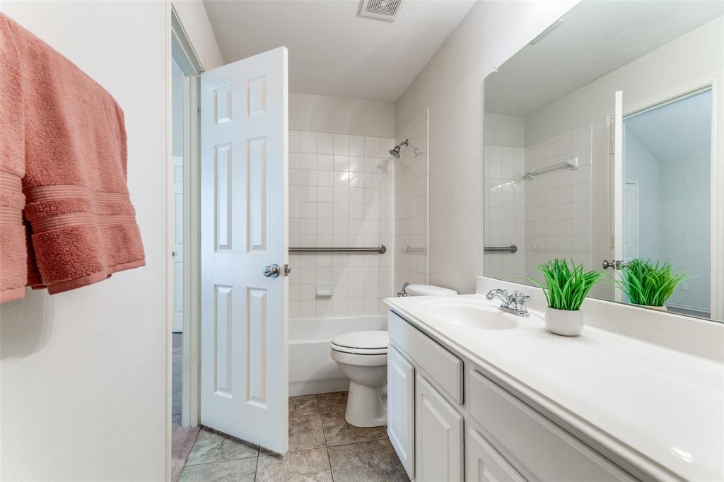 5213 Westheimer Road Fort Worth, TX 76244 - Photo 20 of 25 a bathroom with a sink a toilet and shower curtain