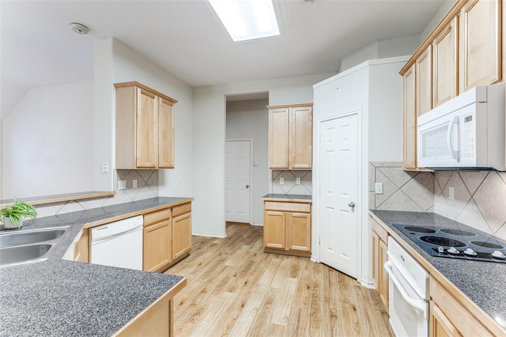5213 Westheimer Road Fort Worth, TX 76244 - Photo 9 of 25 a kitchen with stainless steel appliances granite countertop a stove a sink and a refrigerator