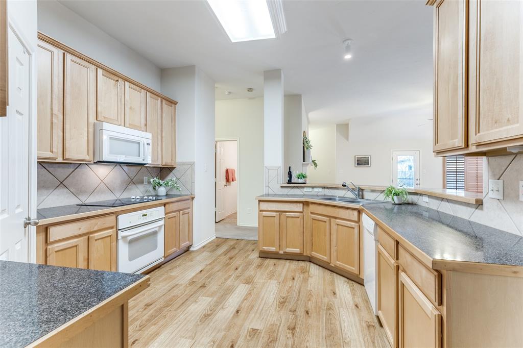 5213 Westheimer Road Fort Worth, TX 76244 - Photo 10 of 25 a large kitchen with granite countertop a sink dishwasher stove and cabinets