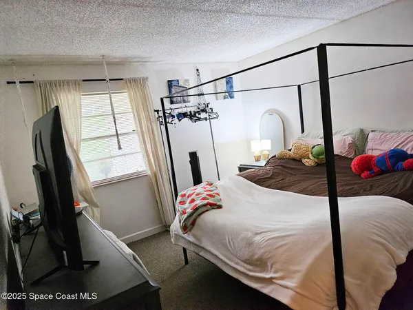 a bedroom with a bed and a walk in closet