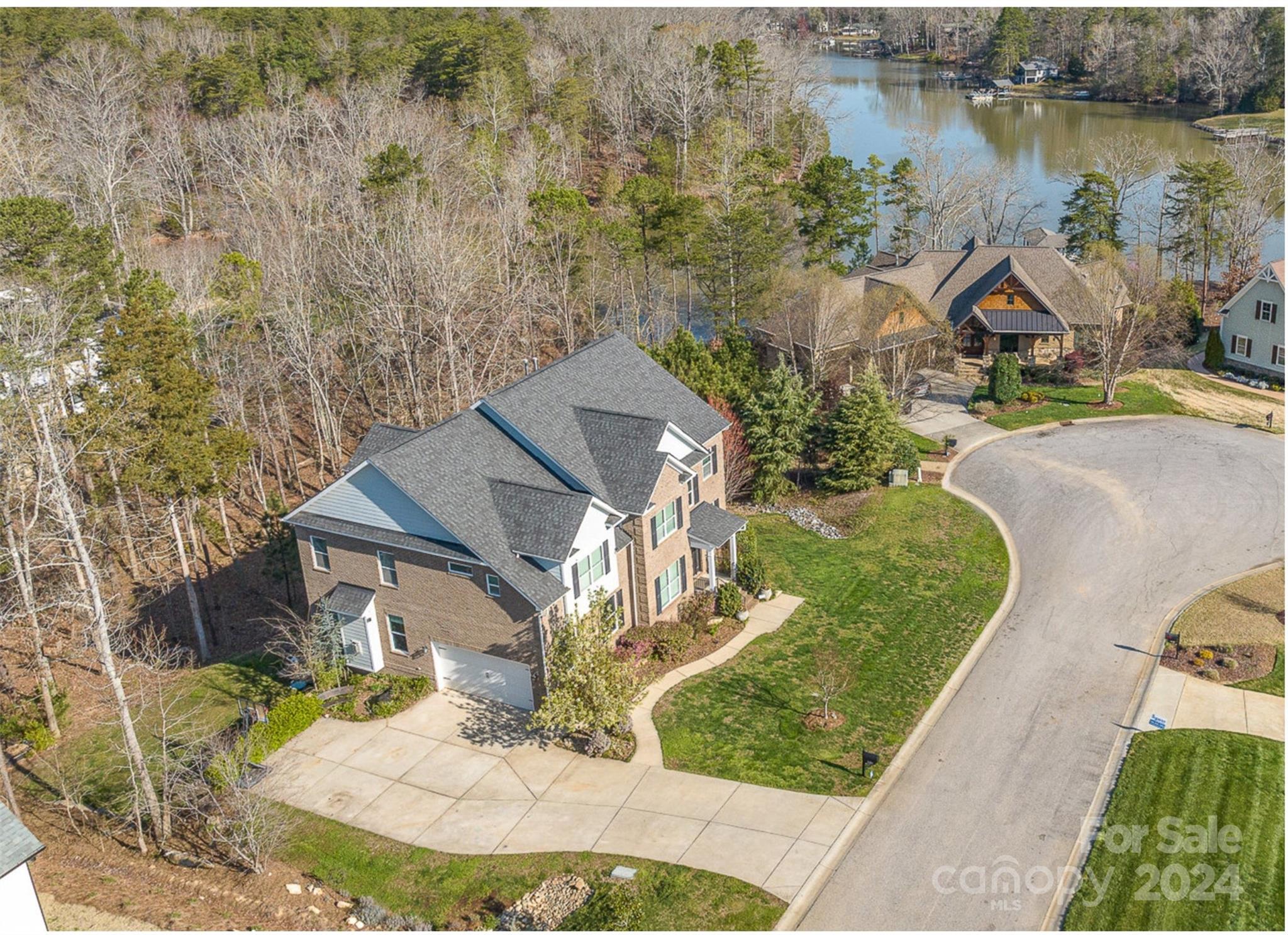 an aerial view of a house with outdoor space lake view
