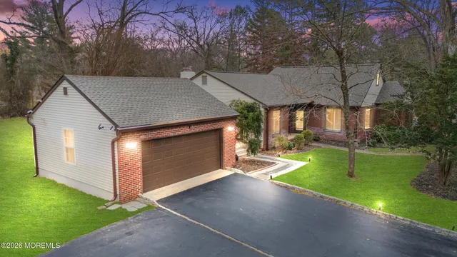 a view of a house with a yard and tree s