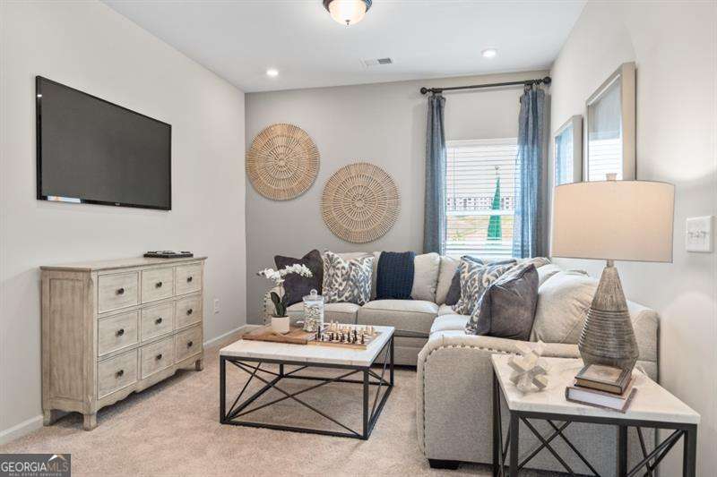 708 Shetland Trail Cartersville, GA 30121 - Photo 12 of 56 a living room with furniture a large window and a flat screen tv