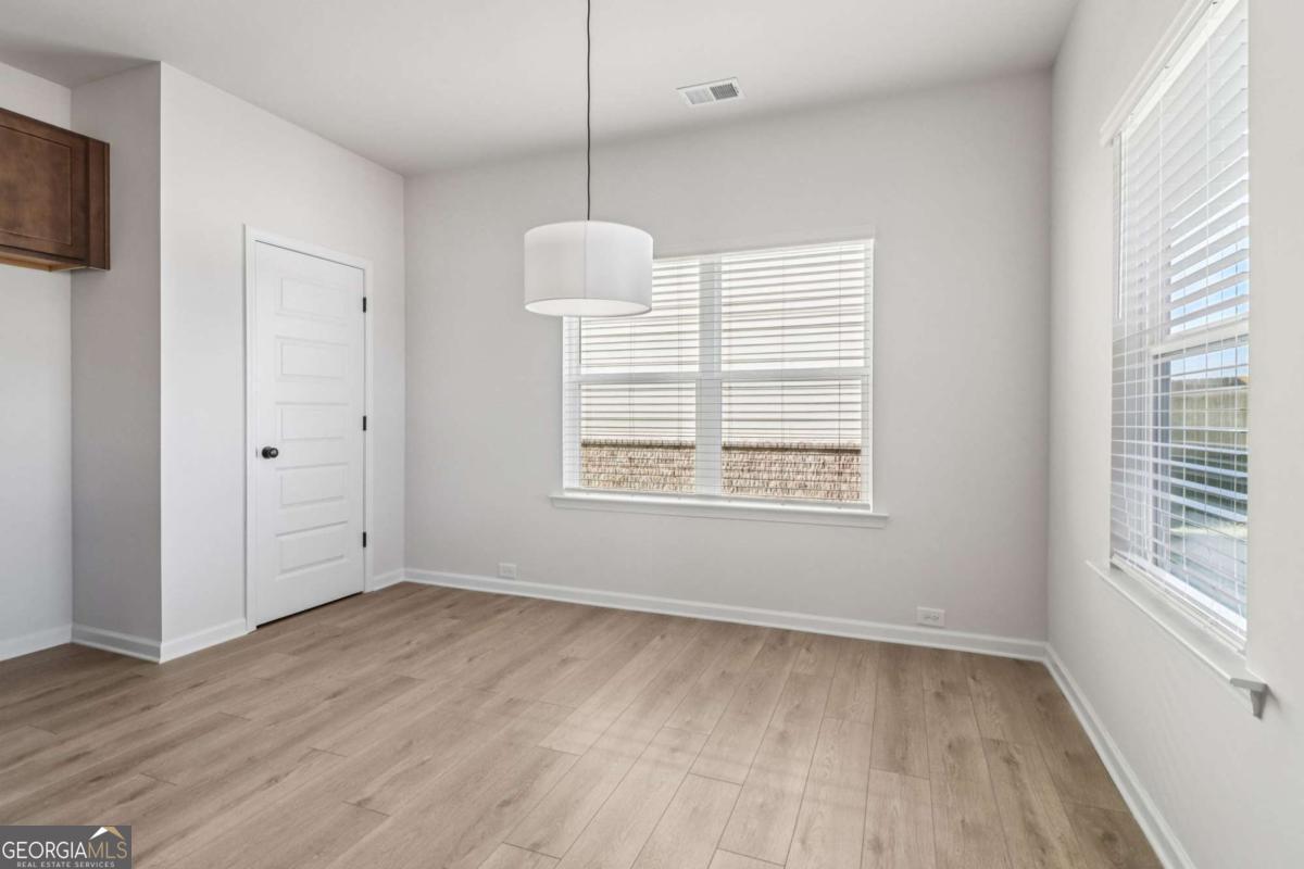 708 Shetland Trail Cartersville, GA 30121 - Photo 13 of 56 a view of an empty room with wooden floor and a window