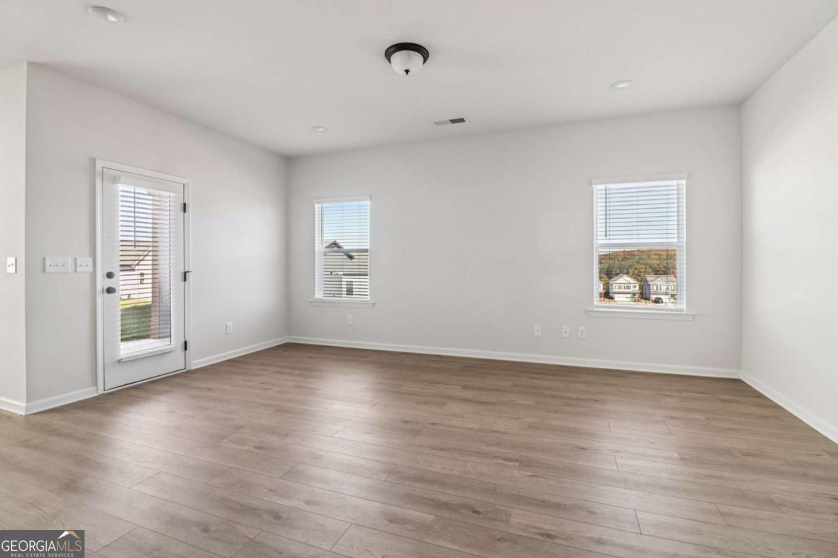 708 Shetland Trail Cartersville, GA 30121 - Photo 17 of 56 an empty room with wooden floor and windows