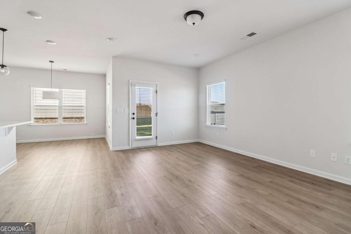 708 Shetland Trail Cartersville, GA 30121 - Photo 18 of 54 an empty room with wooden floor and windows