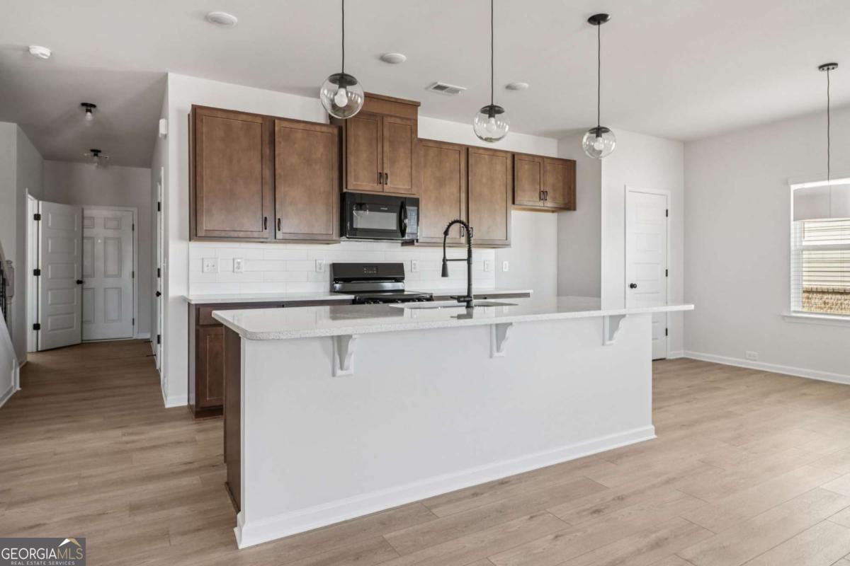 708 Shetland Trail Cartersville, GA 30121 - Photo 22 of 54 a view of kitchen with stainless steel appliances granite countertop cabinets and a wooden floor