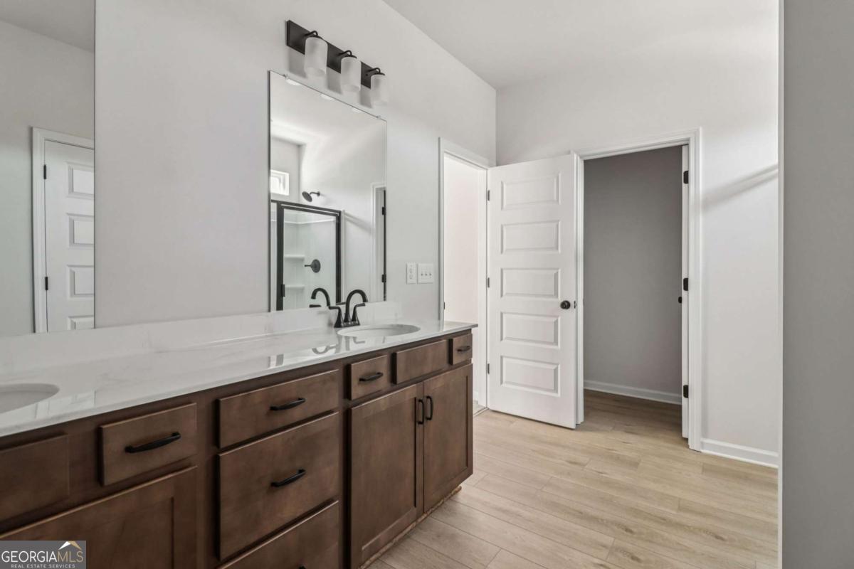 708 Shetland Trail Cartersville, GA 30121 - Photo 40 of 54 a bathroom with a double vanity sink and mirror with shower