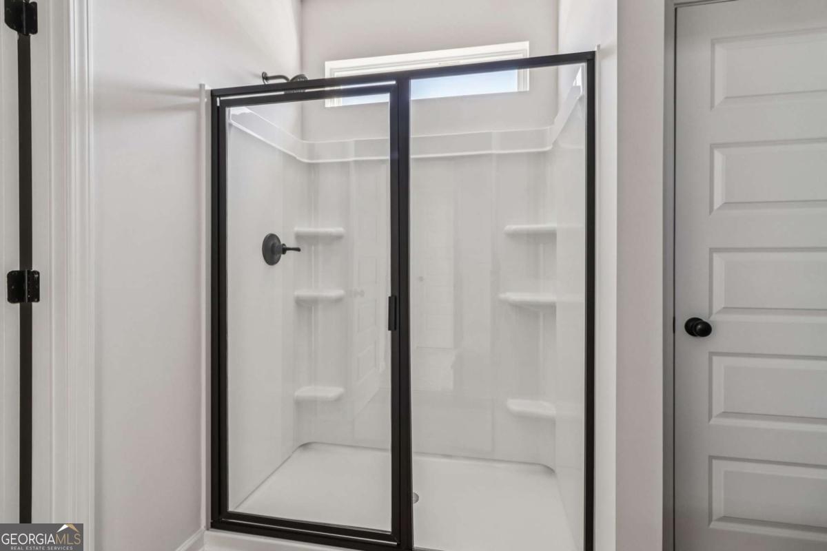 708 Shetland Trail Cartersville, GA 30121 - Photo 41 of 54 a bathroom with a glass shower door