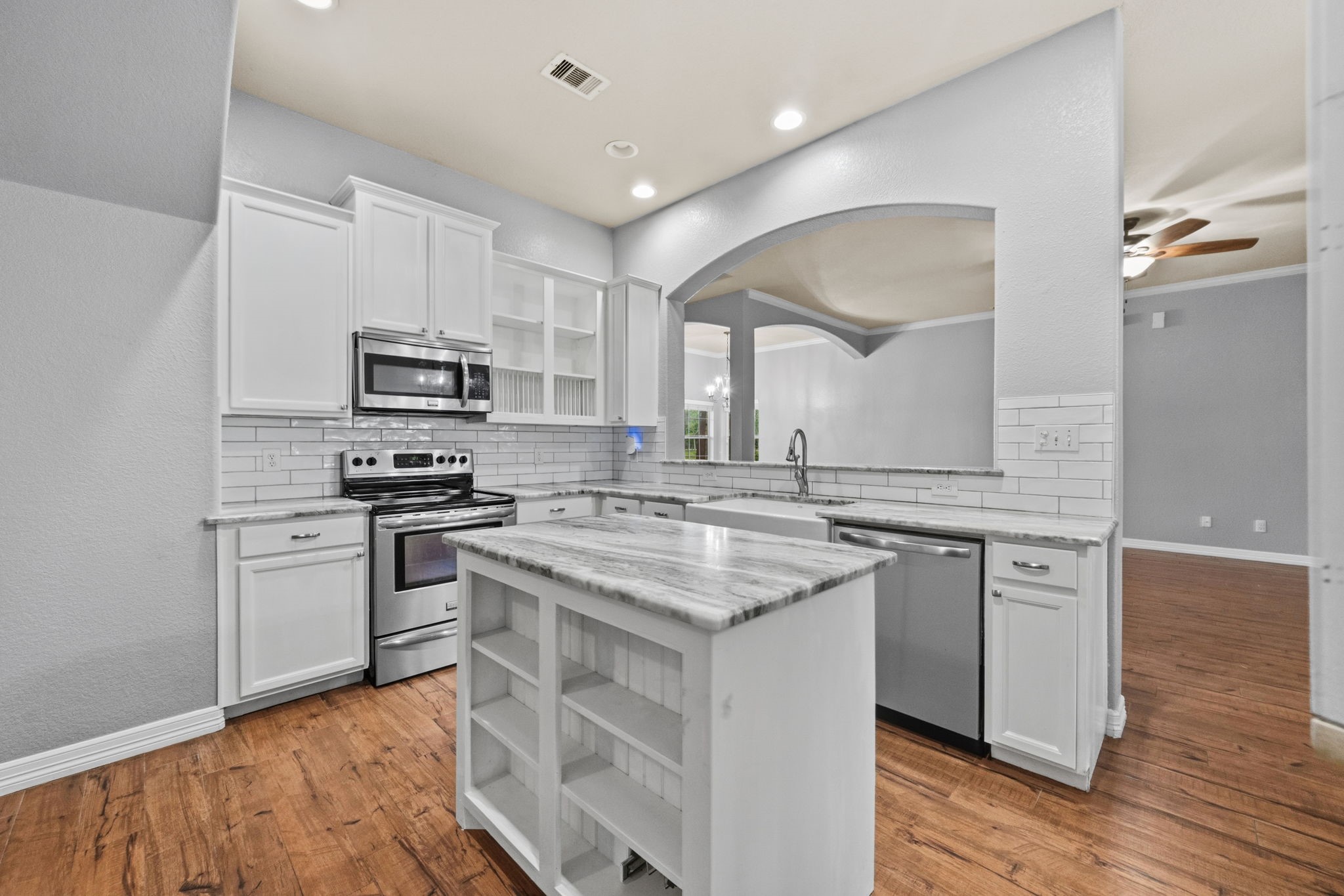 1405 Big Hill Road Winnie, TX 77665 - Photo 27 of 43 a kitchen with stainless steel appliances granite countertop a sink and stove top oven