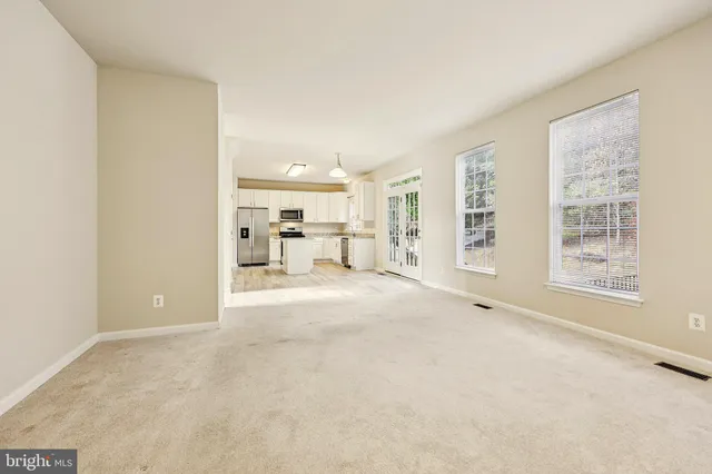 a kitchen with granite countertop white cabinets sink and stainless steel appliances
