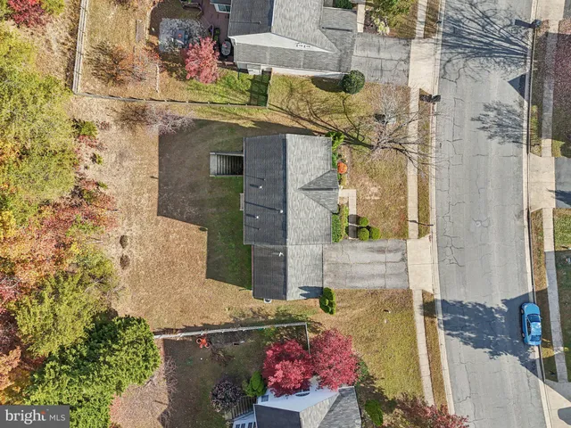 a front view of a house with a garden and trees