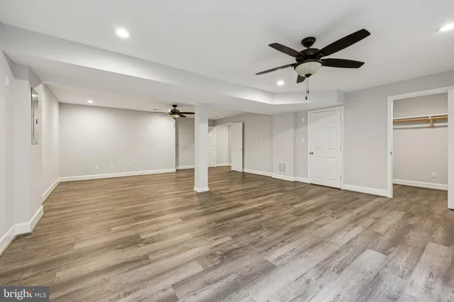 an empty room with a fireplace and windows