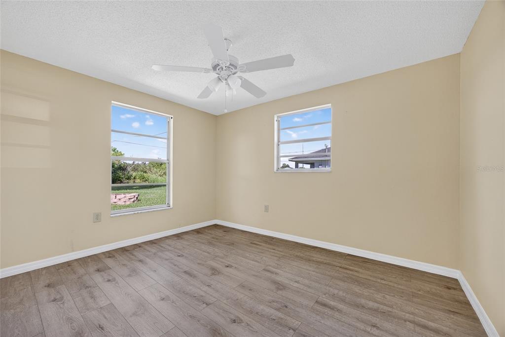 12337 Buffing Road, Unit A AND B Port Charlotte, FL 33981 - Photo 16 of 27 a view of an empty room with wooden floor and a window