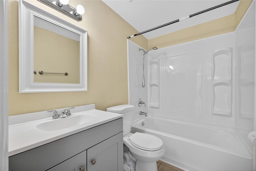 12337 Buffing Road, Unit A AND B Port Charlotte, FL 33981 - Photo 17 of 27 a bathroom with a sink a toilet and a bathtub