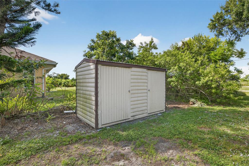 12337 Buffing Road, Unit A AND B Port Charlotte, FL 33981 - Photo 21 of 27 a backyard of a house with lots of green space