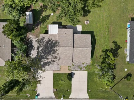 an aerial view of a house with a yard
